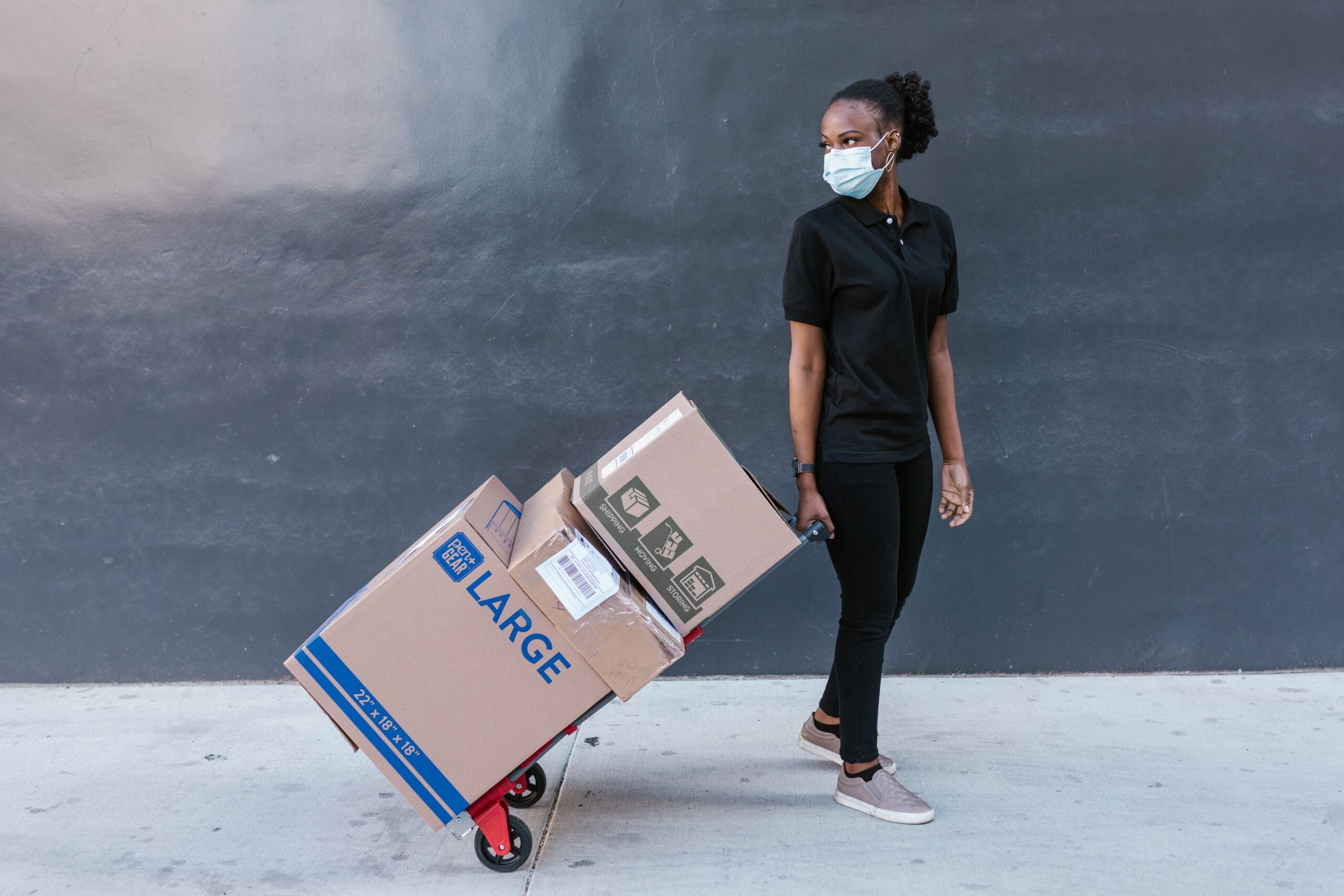 Logistics worker handling corrugated packaging